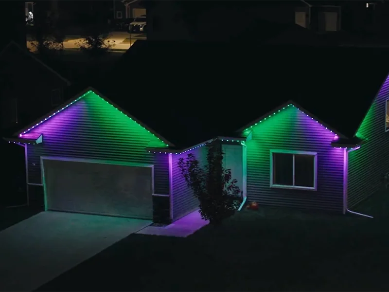 Home exterior with purple and green permanent lighting